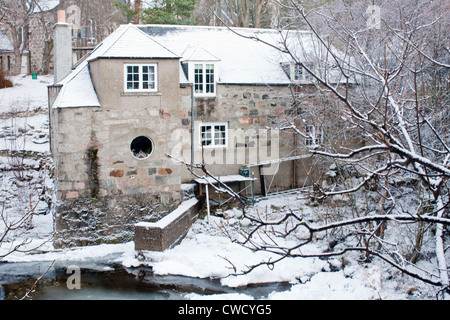 House on the river Dee covered in snow Stock Photo
