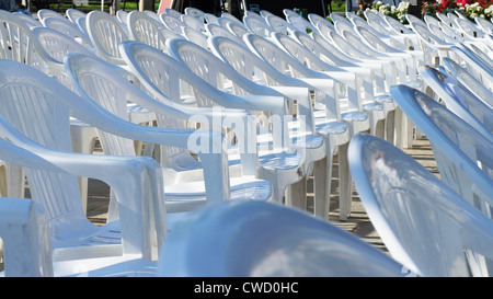 Array of empty white chairs ready for an exhibition Stock Photo