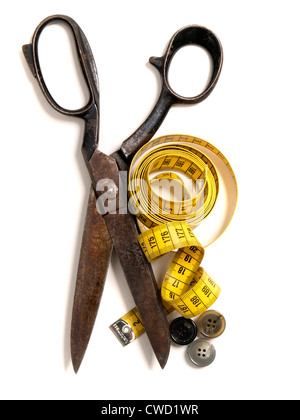 Old scissors with yellow tape measure and buttons tools for tailoring Stock Photo