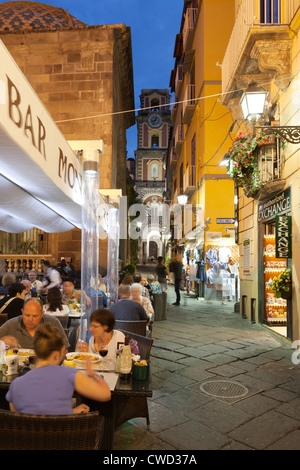 Evening restaurant scene on the Via San Cesareo with the Campanile de la Cattedrale Stock Photo