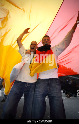 Berlin, 2006 World Cup soccer fans: cheering Santander youth under huge Germany flag Stock Photo