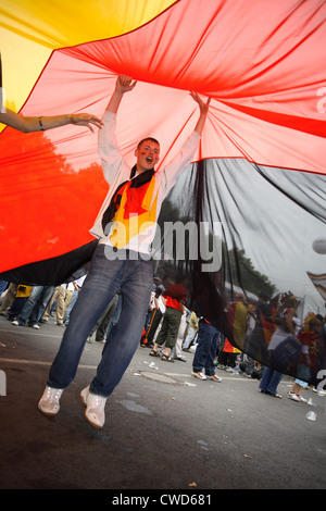 Berlin, 2006 World Cup soccer fans: cheering Santander teenager under huge Germany flag Stock Photo