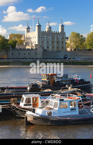 Moored boats on River Thames in front of the Tower of London, London, England Stock Photo