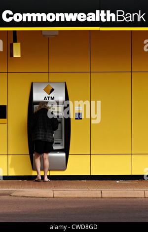 Person standing at a Australian Commonwealth Bank automat teller machine Stock Photo