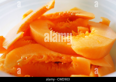 Close-up view of slices of cantaloupe in a white bowl Stock Photo