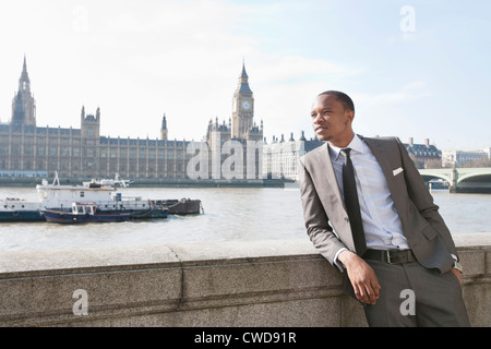 African American businessman leaning with hand in pocket Stock Photo