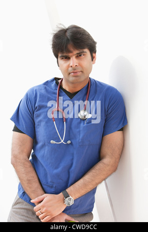 Portrait of an Indian male doctor leaning over white background Stock Photo