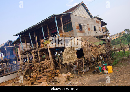 Horizontal wide angle view of the stilted grass houses of Kompong Khleang, the floating village on Tonle Sap Lake in Cambodia Stock Photo