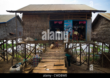 Horizontal wide angle view of the stilted grass houses of Kompong Khleang, the floating village on Tonle Sap Lake in Cambodia Stock Photo