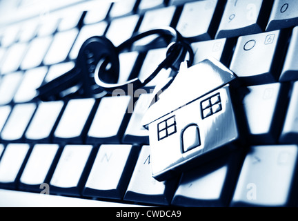 Mortgage concept with keys and house-shaped key ring on laptop keyboard Stock Photo