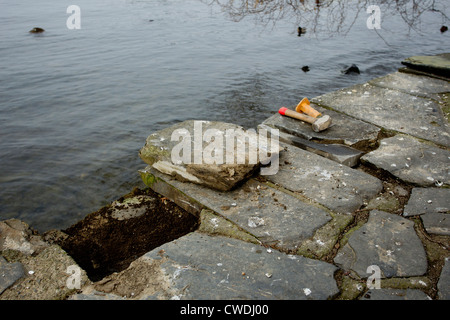 Repairs to Lakeland stone path on the edge of Lake  Windermere Stock Photo