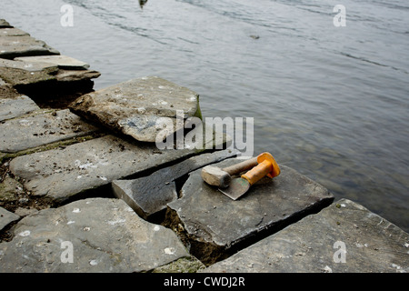 Repairs to Lakeland stone path on the edge of Lake  Windermere Stock Photo