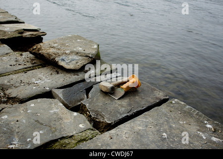 Repairs to Lakeland stone path on the edge of Lake  Windermere Stock Photo