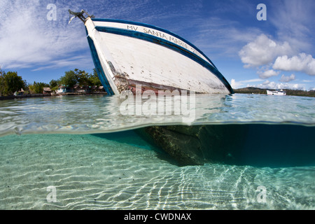 A small ship has recently sunk on a sandy slope where it will eventually become an artificial reef and home to corals and fish. Stock Photo