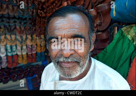 Local man selling shoes, Anjuna, Goa, India Stock Photo