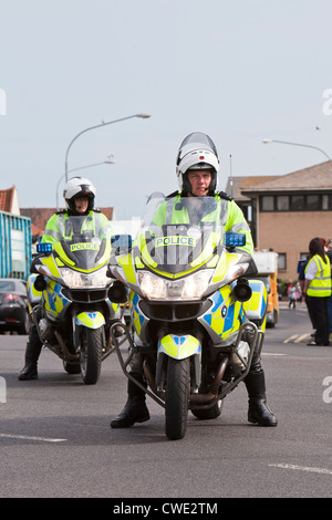 Metropolitan Police motorcycle outriders in Great Yarmouth during the London 2012 Olympic Torch Relay Stock Photo