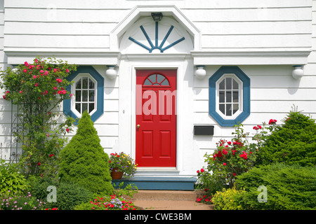 A bright red door on the entrance of a home. Stock Photo