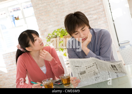 Young couple talking at dining table Stock Photo