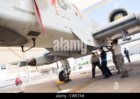 Airmen attach a external fuel tank to an A-10 Thunderbolt from the 354th Fighter Squadron at Davis-Monthan Air Force Base. Stock Photo