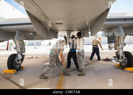 Airmen attach a external fuel tank to an A-10 Thunderbolt from the 354th Fighter Squadron at Davis-Monthan Air Force Base. Stock Photo