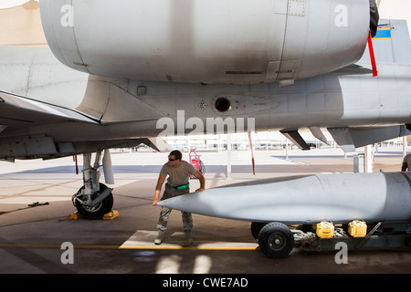 Airmen attach a external fuel tank to an A-10 Thunderbolt from the 354th Fighter Squadron at Davis-Monthan Air Force Base. Stock Photo