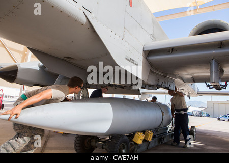 Airmen attach a external fuel tank to an A-10 Thunderbolt from the 354th Fighter Squadron at Davis-Monthan Air Force Base. Stock Photo