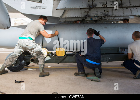 Airmen attach a external fuel tank to an A-10 Thunderbolt from the 354th Fighter Squadron at Davis-Monthan Air Force Base. Stock Photo