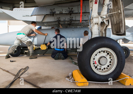 Airmen attach a external fuel tank to an A-10 Thunderbolt from the 354th Fighter Squadron at Davis-Monthan Air Force Base. Stock Photo