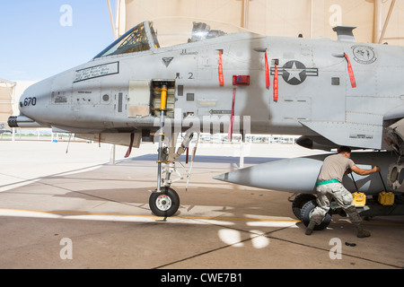 Airmen attach a external fuel tank to an A-10 Thunderbolt from the 354th Fighter Squadron at Davis-Monthan Air Force Base. Stock Photo