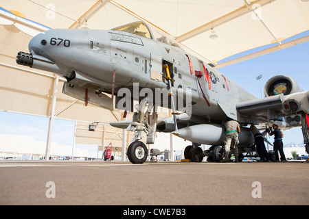 Airmen attach a external fuel tank to an A-10 Thunderbolt from the 354th Fighter Squadron at Davis-Monthan Air Force Base. Stock Photo