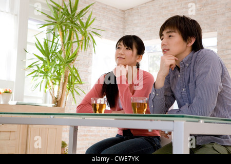 Young couple sitting at dining table Stock Photo