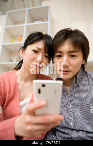 Young couple using smartphone Stock Photo
