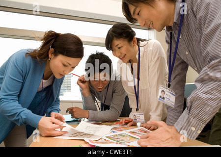 Four businesspeople in casual clothing having meeting Stock Photo