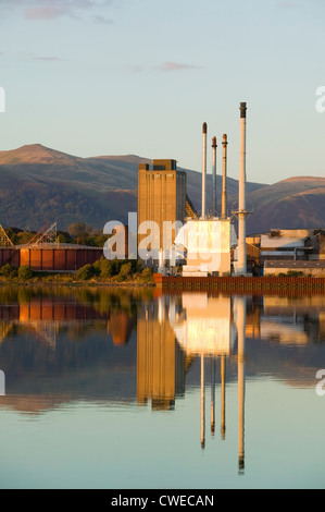 The United Glass Limited Glass Works in Alloa, Clackmannanshire, Scotland, UK. Reflected in the River Forth. Stock Photo