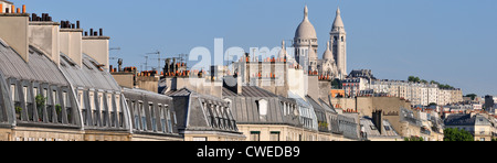 Paris, France. Paris, France. Basilica of Sacré Cœur de Montmartre (Arch. Paul Abadie: 1875-1914) and rooftops along Boulevard de Magenta. Panorama Stock Photo