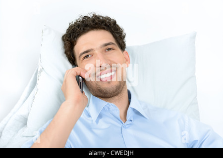 Young handsome man with modern mobile phone. Studio shot. Stock Photo