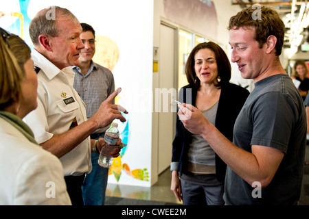 Mark Zuckerberg, Facebook founder and CEO, receives a challenge coin from US Army General Martin Dempsey, chairman of the Joint Chiefs of Staff, at Facebook headquarters July 26, 2012 in Mountain View, California. Stock Photo