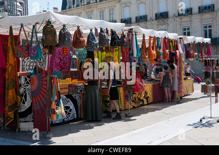 A market stall selling colourful fabrics and bags in the Place de la Comedie, Montpellier, southern France. Stock Photo