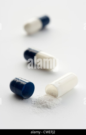Opened medicinal capsule Stock Photo