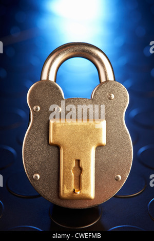 Golden Locked Padlock on the blue background Stock Photo - Alamy