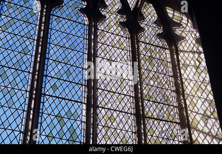 Detail of large clear diamond-leaded 15th century Gothic Perpendicular church window with sky beyond Stock Photo