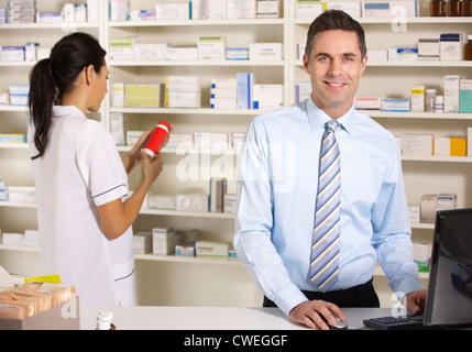 UK nurse and pharmacist working in pharmacy Stock Photo