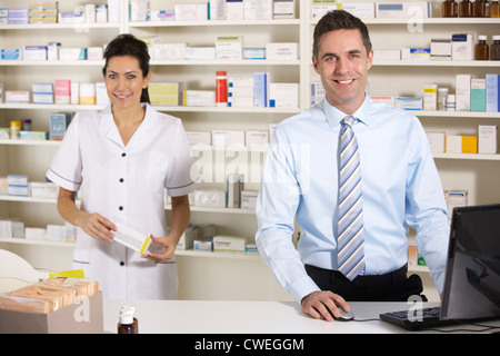 UK nurse and pharmacist working in pharmacy Stock Photo