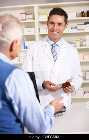 American pharmacist with senior man in pharmacy Stock Photo