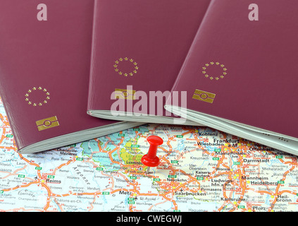 Schengen on the map marked with a red a pin and EU passports Stock Photo