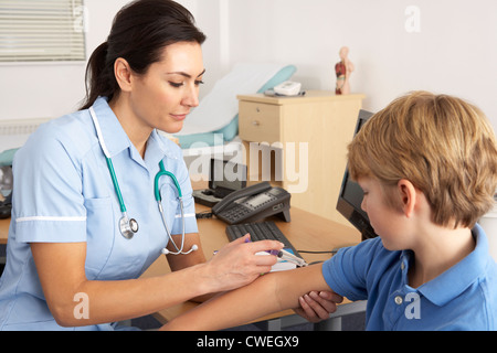 British nurse giving injection to child Stock Photo