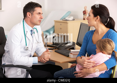 American doctor talking to worried mother Stock Photo