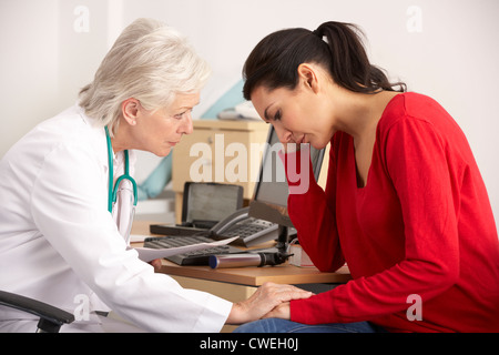 American doctor with depressed woman patient Stock Photo