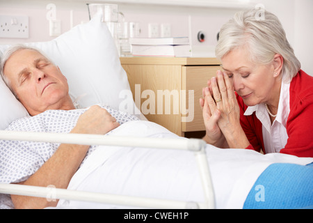 Senior woman with seriously ill husband in hospital Stock Photo
