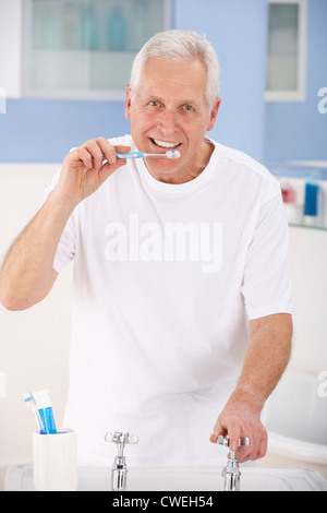 Senior man brushing teeth Stock Photo